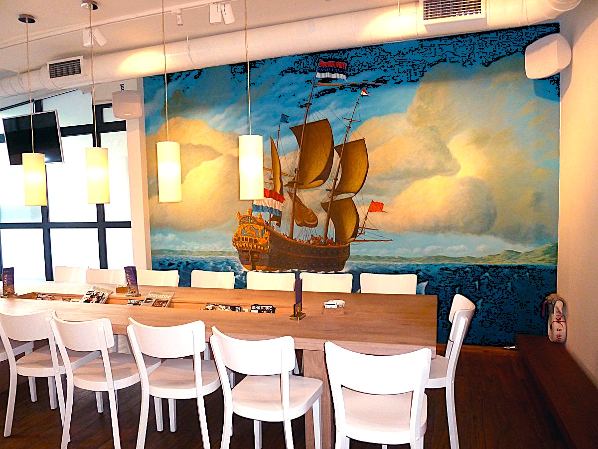 Restaurant interior with a painted sailing ship mural