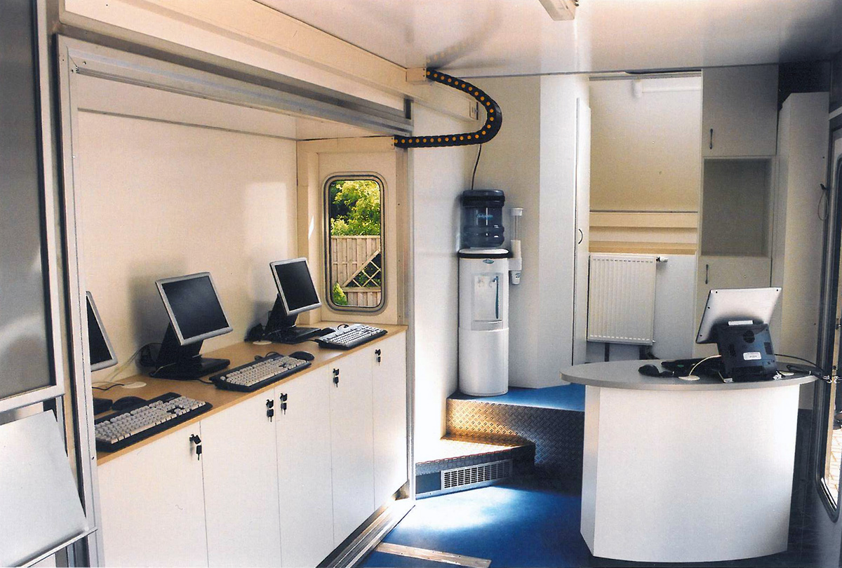 Interior of a UPC mobile service unit with workstations