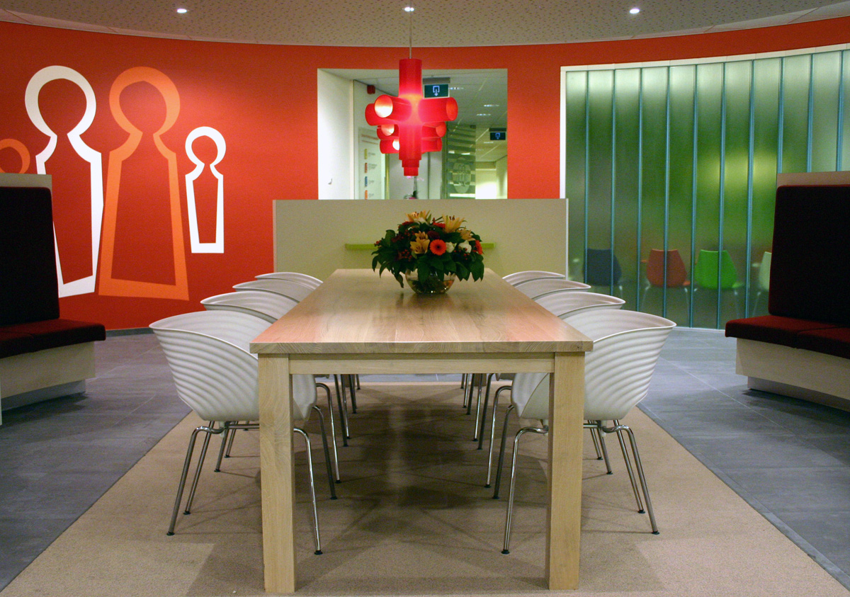 Orange meeting room with wall graphics at health centre Savalle